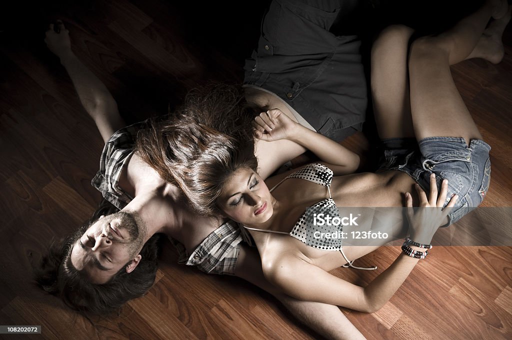 A couple of young lovers staying on floor.